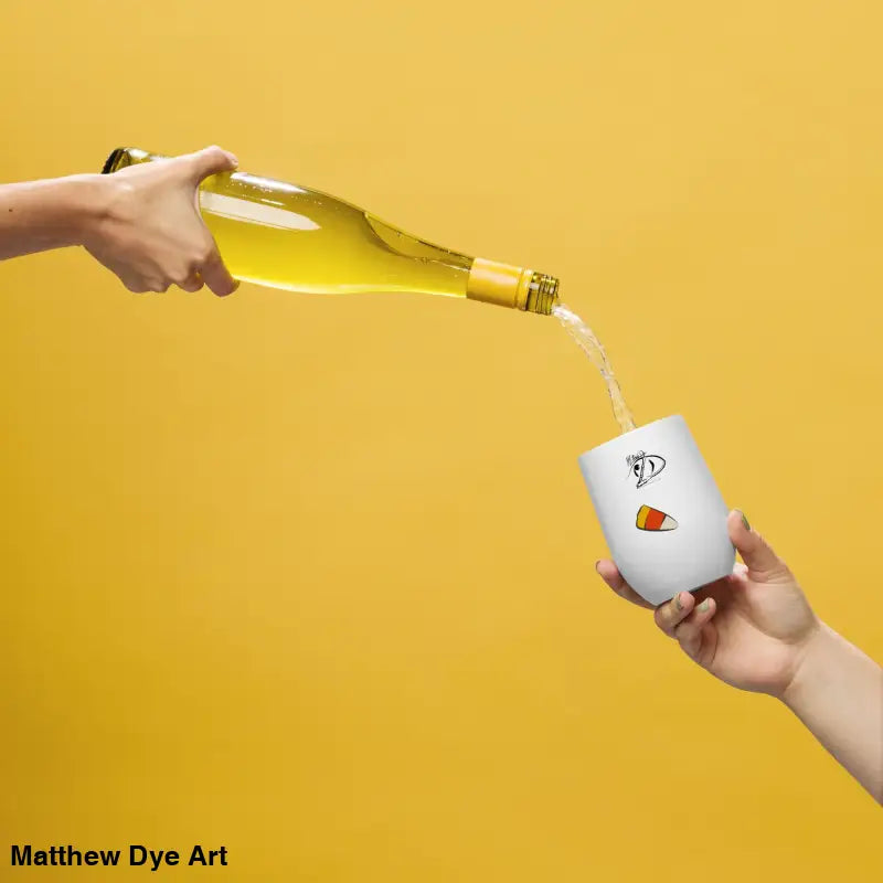 White wine being poured into Pharaoh’s Curse Tumbler, featuring Matthew Dye art