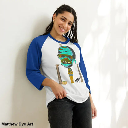 Blue-sleeved raglan shirt featuring Matthew Dye art of a mystical mummy charm