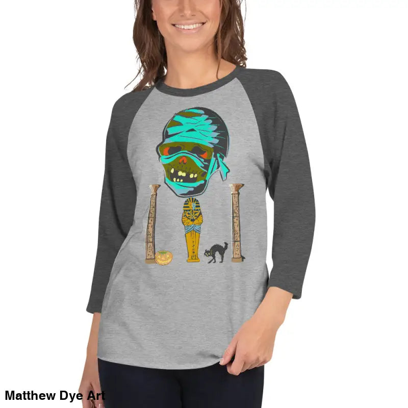 Gray raglan shirt featuring Matthew Dye art of a mystical mummy charm for Halloween