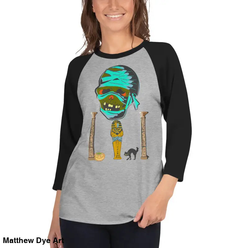 Gray raglan shirt featuring Matthew Dye art with a mystical mummy charm graphic