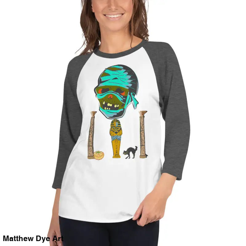 Raglan shirt featuring Matthew Dye art of a mystical mummy charm for Halloween enthusiasts