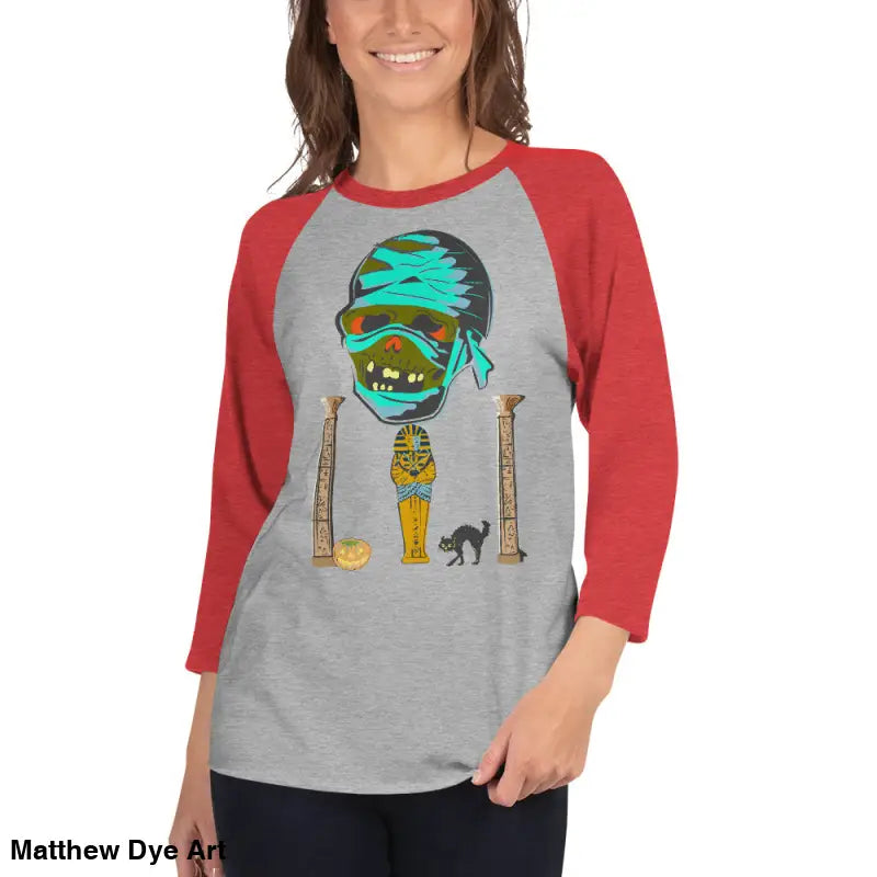 Red and gray Halloween-themed raglan shirt featuring Matthew Dye art of a mystical mummy charm