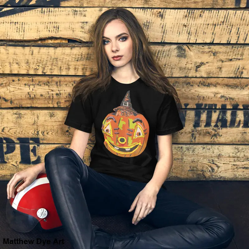 Black t-shirt featuring pumpkin witch graphic, perfect for a comfortable Halloween look
