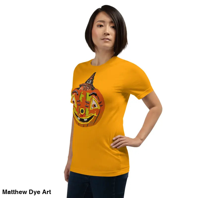 Woman in orange Halloween t-shirt showcasing Pumpkin Witch Mischief design