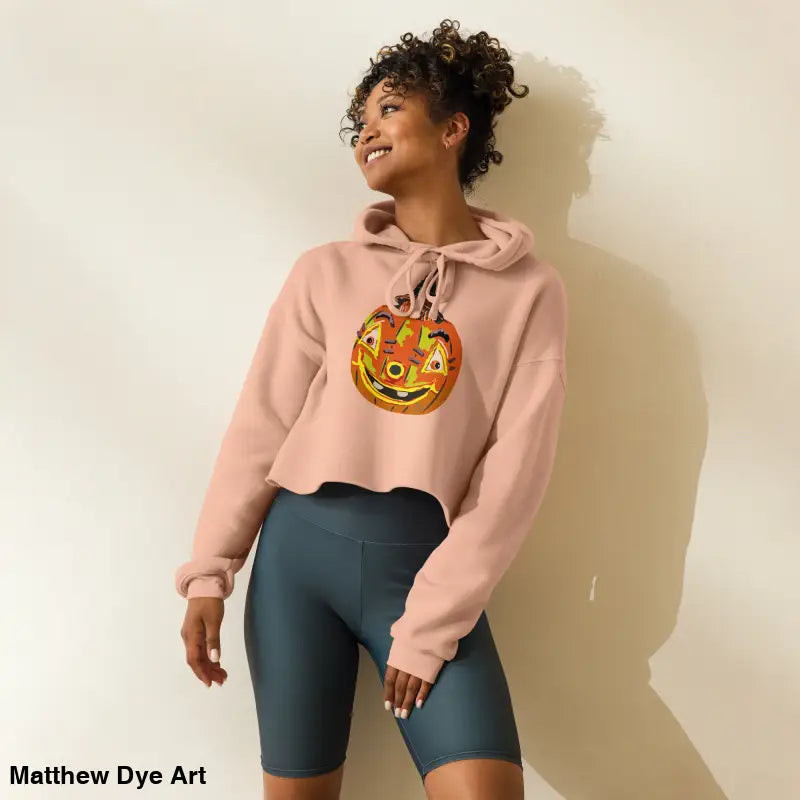 Woman wearing a Pumpkin Witch Spellbound hoodie showcasing an enchanted pumpkin witch design