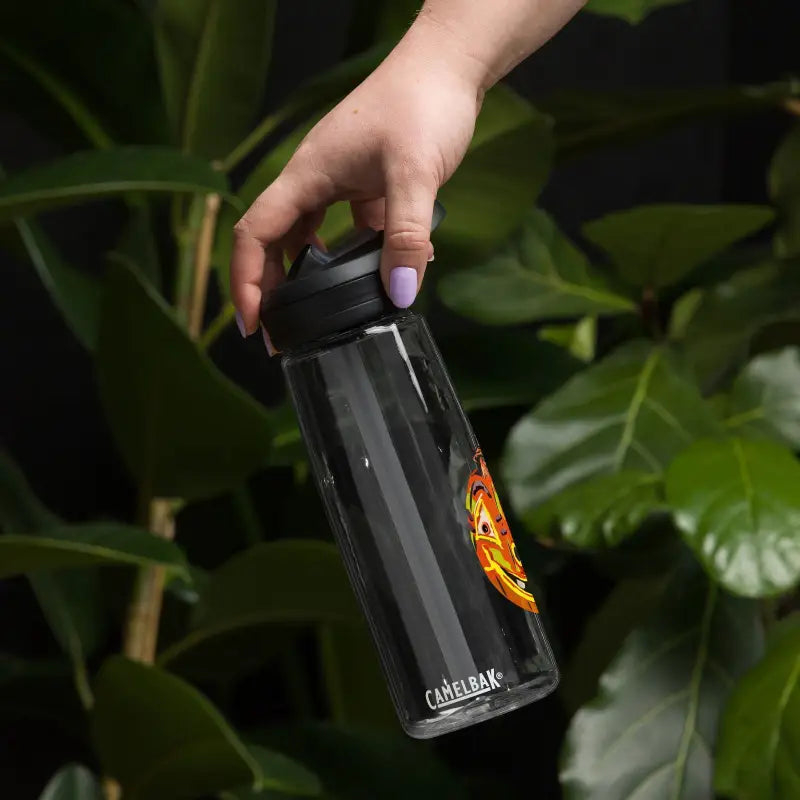 Black CamelBak water bottle with orange logo held by hand with purple nail polish