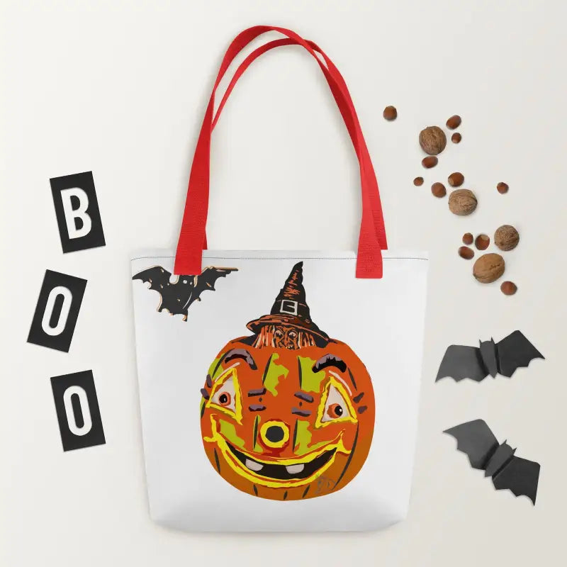 White tote bag with red handles featuring a vintage Halloween charm pumpkin witch design