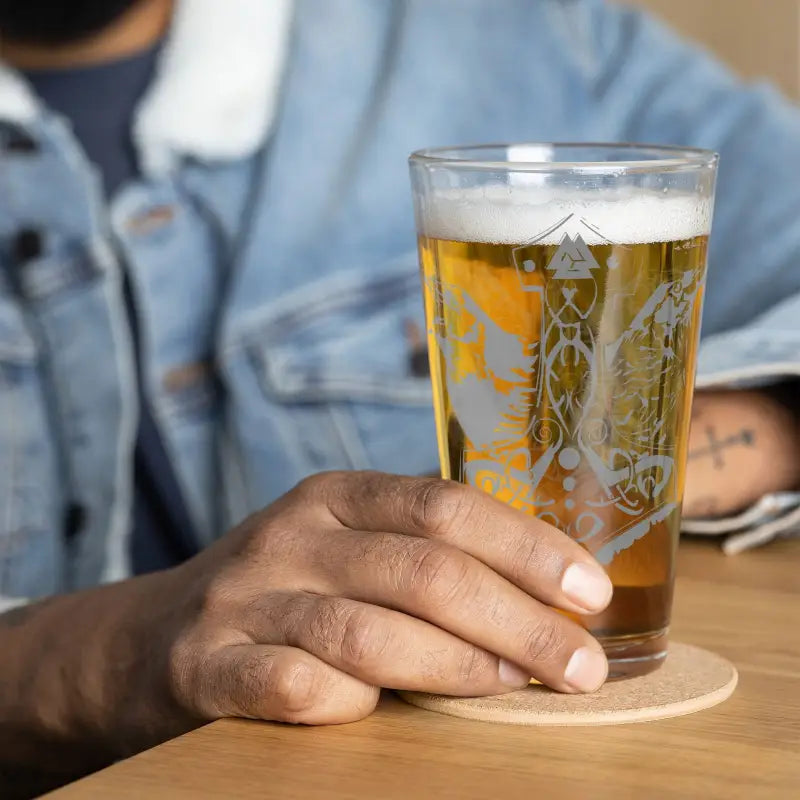 Golden beer with foam in a Raven Design shaker pint glass inspired by Mjölnir