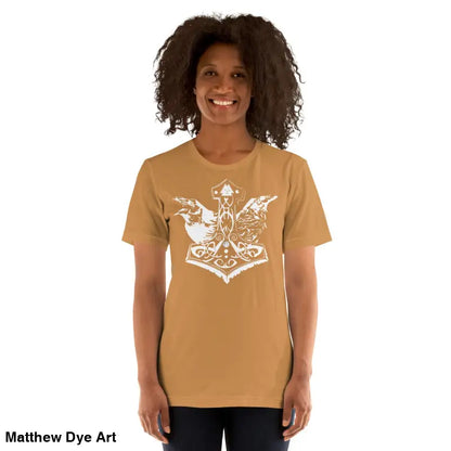 Woman wears a tan Odin’s Chosen Tee featuring a white Norse design for unique style