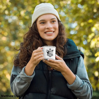 White enamel cup with butterfly design held in hands, perfect for Viking adventures