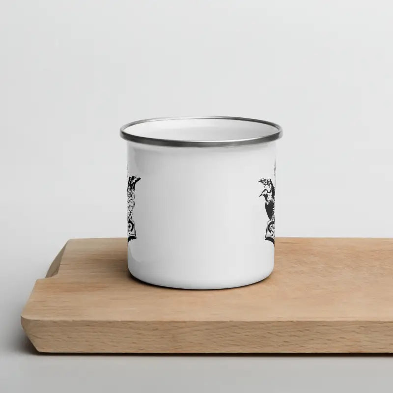 Rugged white enamel cup featuring elegant black designs inspired by Thor’s hammer