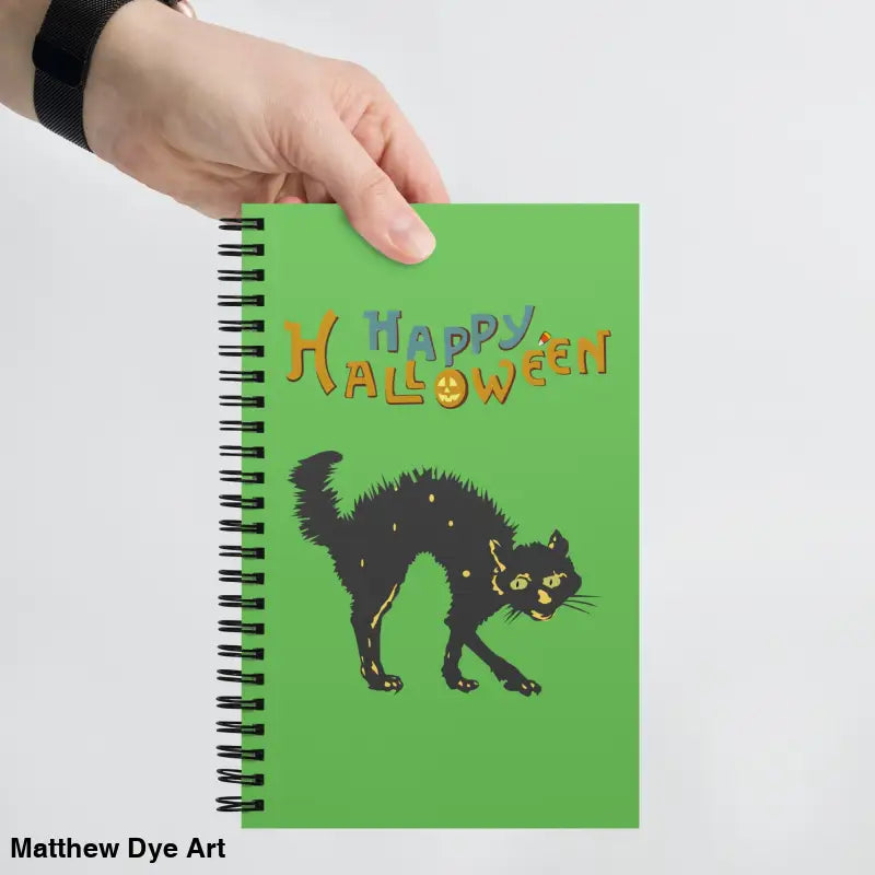 Green Halloween spiral notebook featuring scary cat Halloween artwork for festive note-taking