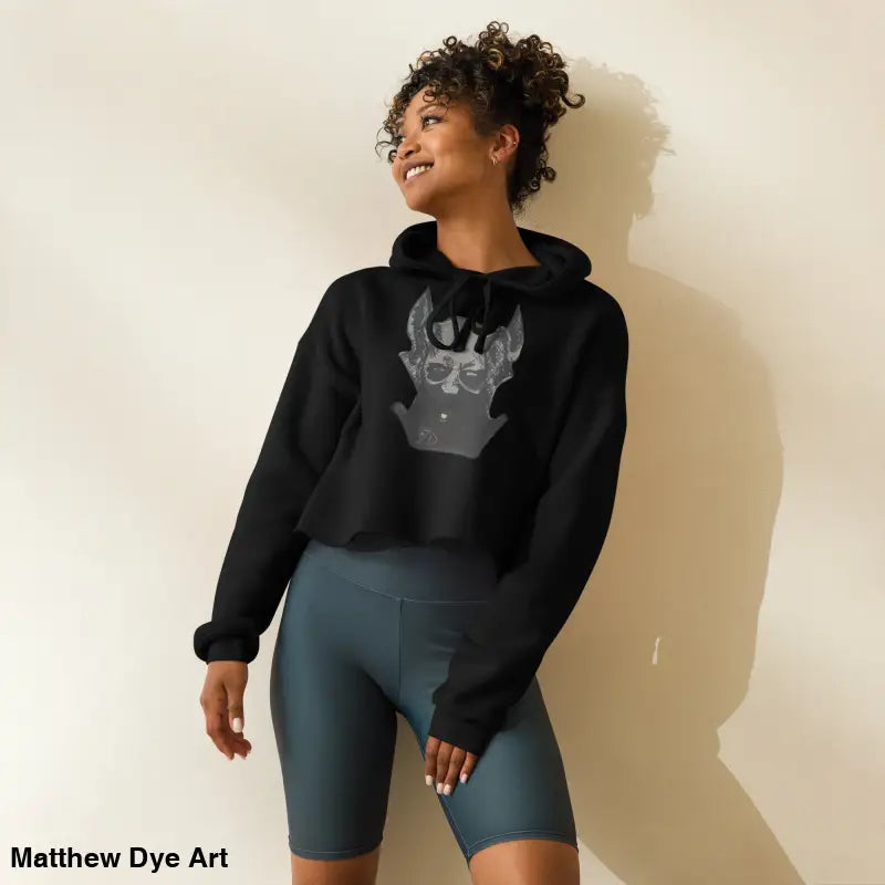 Black cropped hoodie featuring sinister figure design and dropped shoulder cut