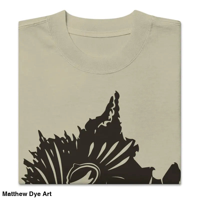 Folded beige oversized faded t-shirt featuring dark floral design from Snarling Nightmare