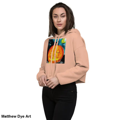 Woman wearing a spooky cute pumpkin-themed crop hoodie with Jack-o’-lantern design