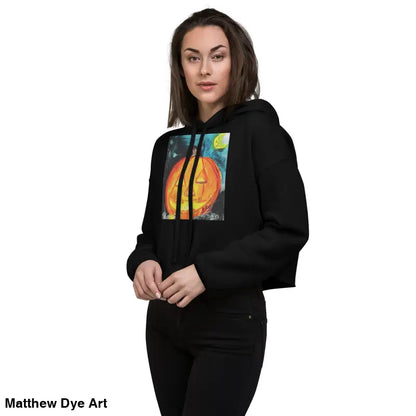 Black cropped hoodie featuring a spooky cute Jack-o’-lantern design by Matthew Dye Art