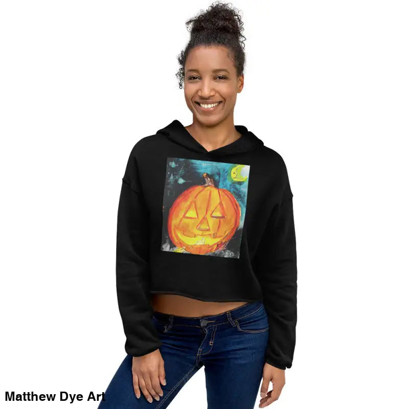 Black cropped hoodie featuring a spooky cute Jack-o’-lantern design by Matthew Dye Art
