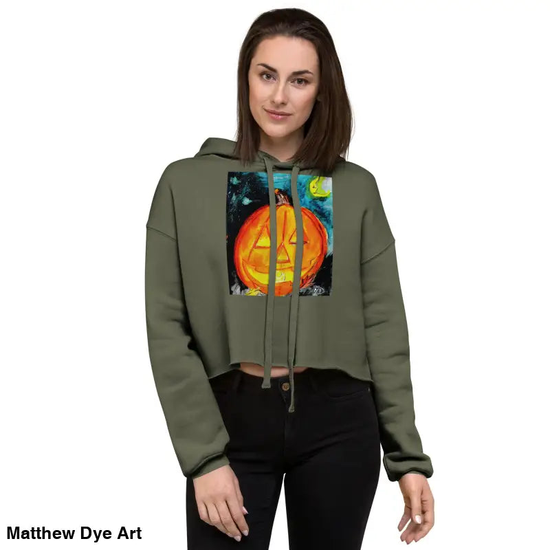 Woman modeling a Spooky Cute & Cozy Pumpkin Glow hoodie with a Jack-o’-lantern design