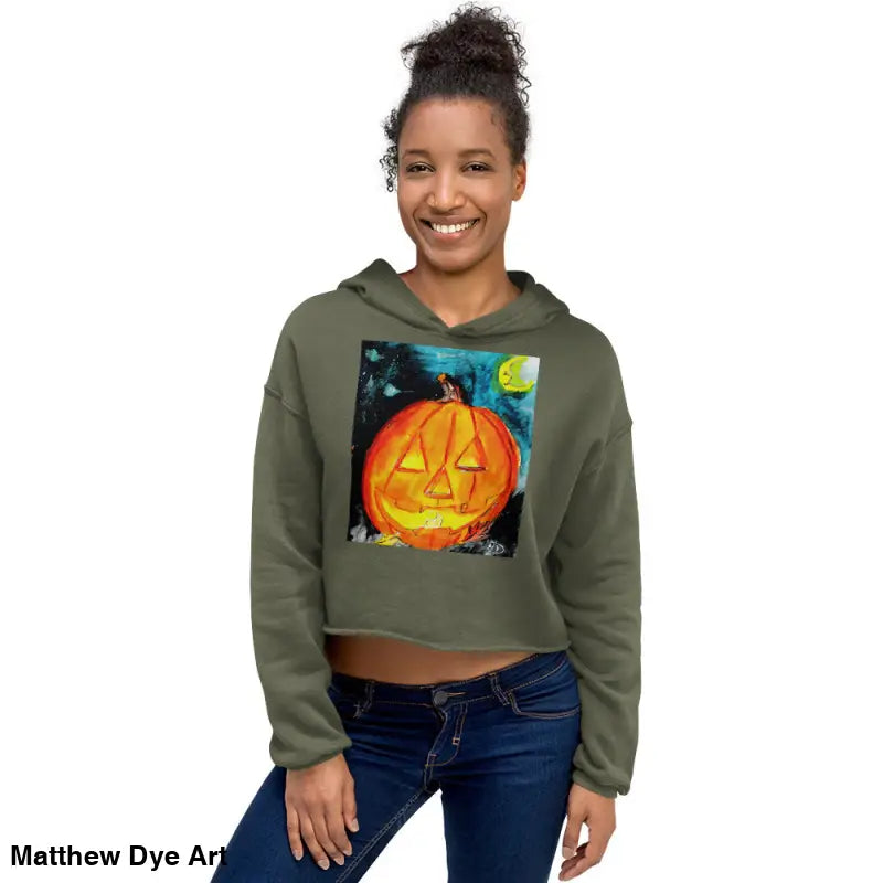 Woman in a Spooky Cute Cropped Hoodie featuring Matthew Dye Art’s Jack-o’-lantern design