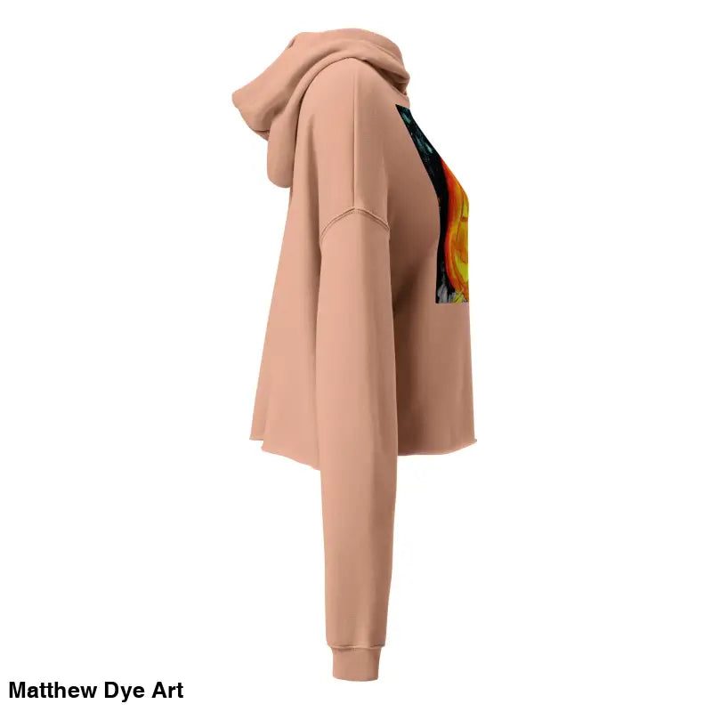 Peach-colored cropped hoodie featuring a spooky cute Jack-o’-lantern design by Matthew Dye Art