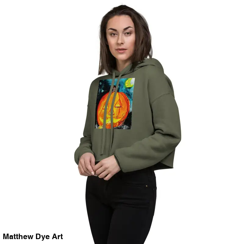 Woman modeling a Spooky Cute Halloween Cropped Hoodie with a Matthew Dye Art jack-o’-lantern design