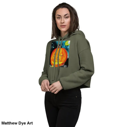 Woman modeling a Spooky Cute Halloween Cropped Hoodie with a Matthew Dye Art jack-o’-lantern design