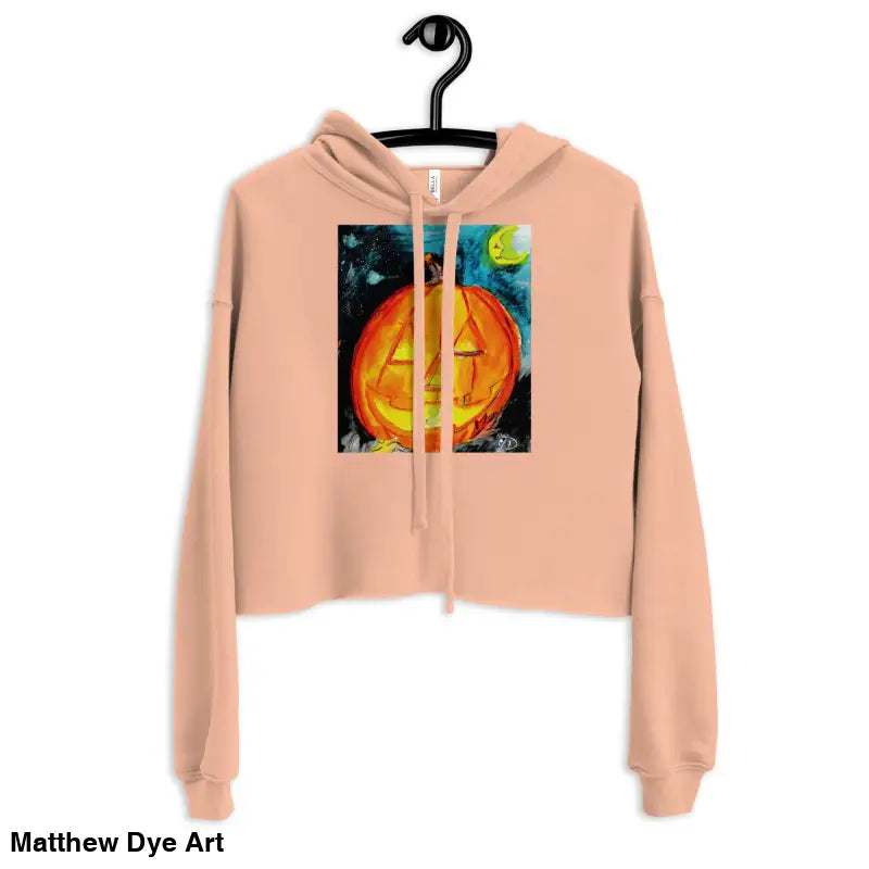 Peach-colored cropped hoodie featuring Spooky Cute pumpkin graphic by Matthew Dye Art