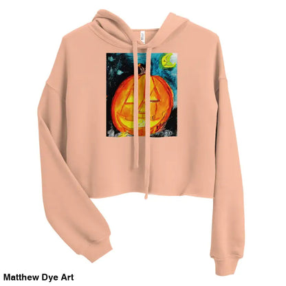 Peach-colored cropped hoodie featuring spooky cute pumpkin graphic by Matthew Dye Art