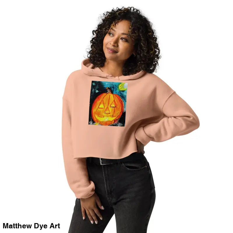 Woman in a spooky cute cropped hoodie featuring a Matthew Dye art jack-o’-lantern design