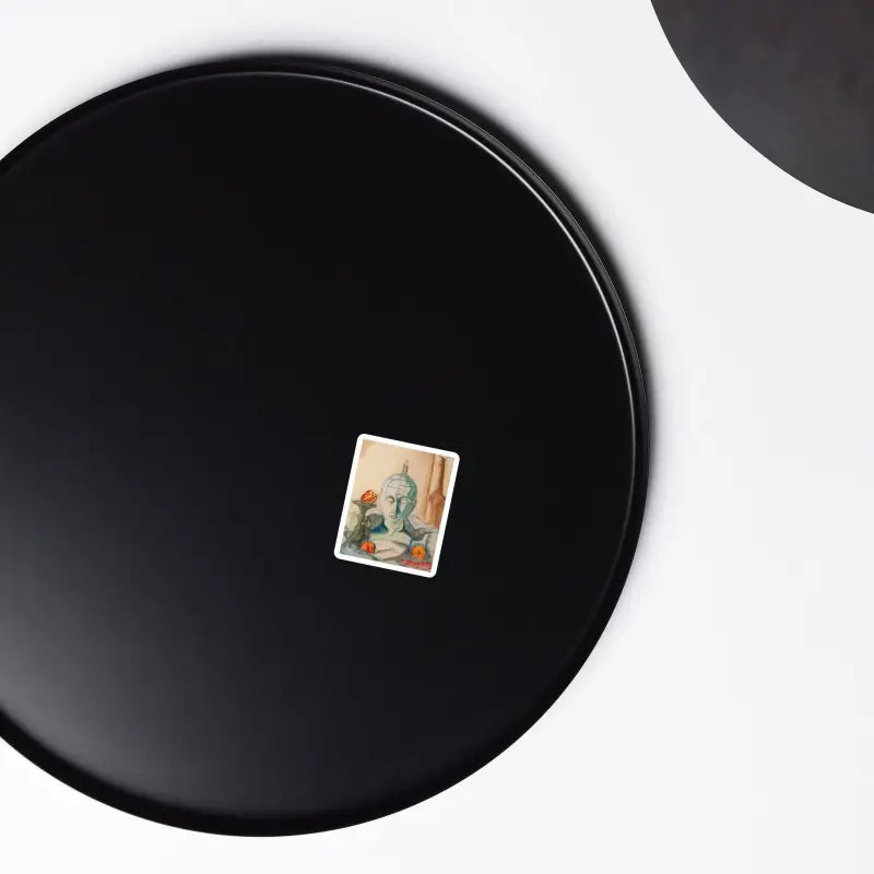 Black circular plate with a small decorative sticker from Stillness of Phrenology Premium Magnet Set