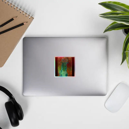 Silver laptop adorned with a colorful holographic vinyl sticker of The Priestess