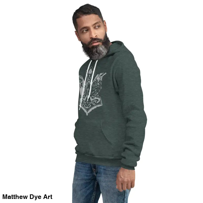 Man in green hoodie featuring Thor’s Mjolnir and Odin’s Ravens design, a comfortable Viking unisex pullover