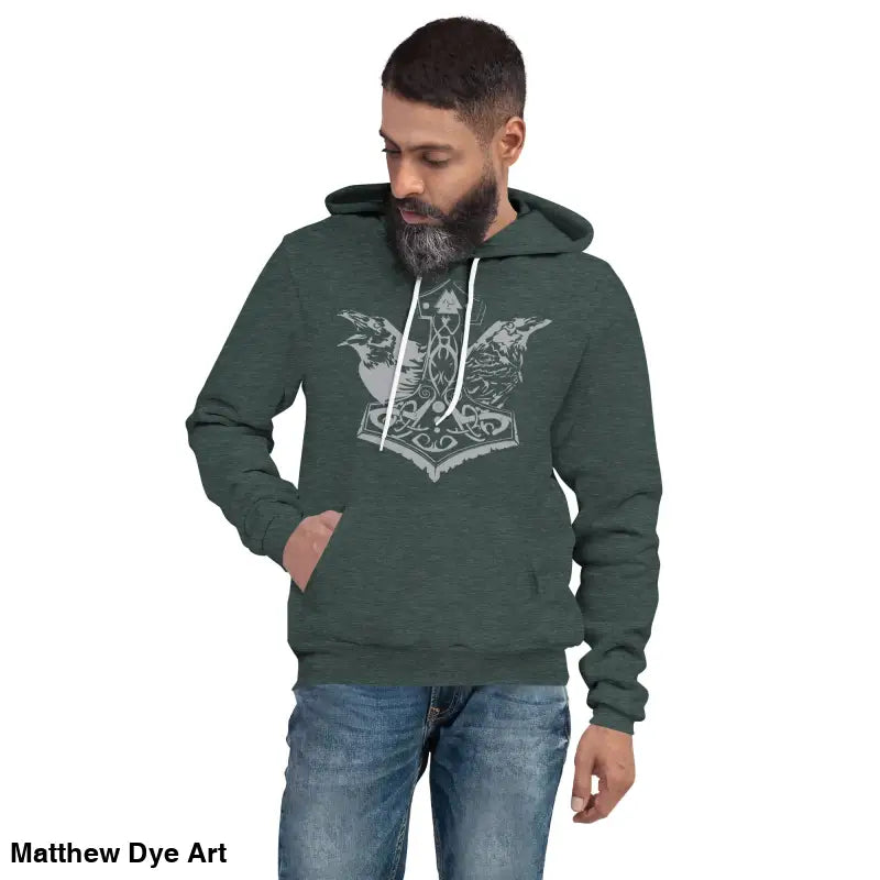 Man wearing a comfortable Viking unisex pullover hoodie featuring Thor’s Mjolnir and Odin’s Ravens
