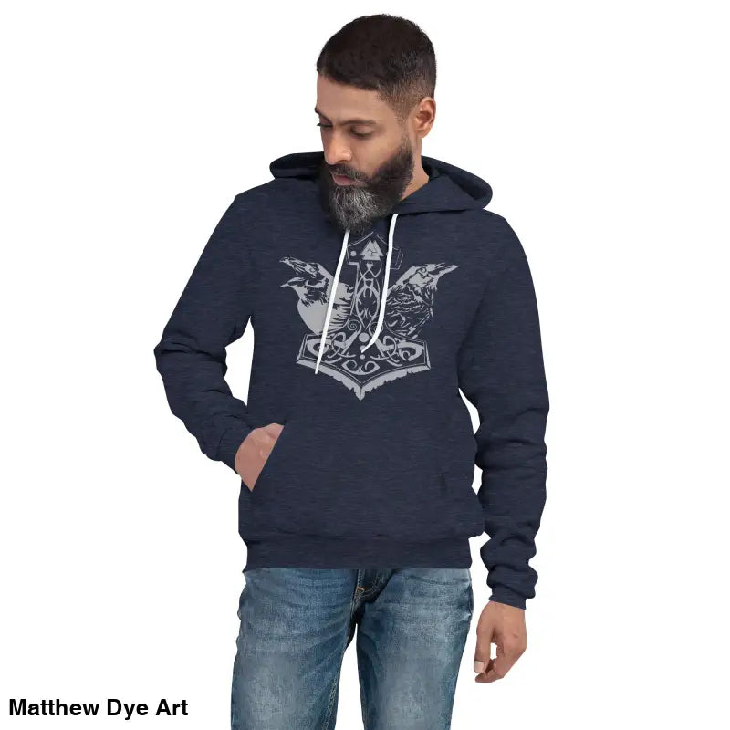 Man wearing a comfortable Viking unisex pullover hoodie featuring Thor’s Mjolnir and Odin’s Ravens