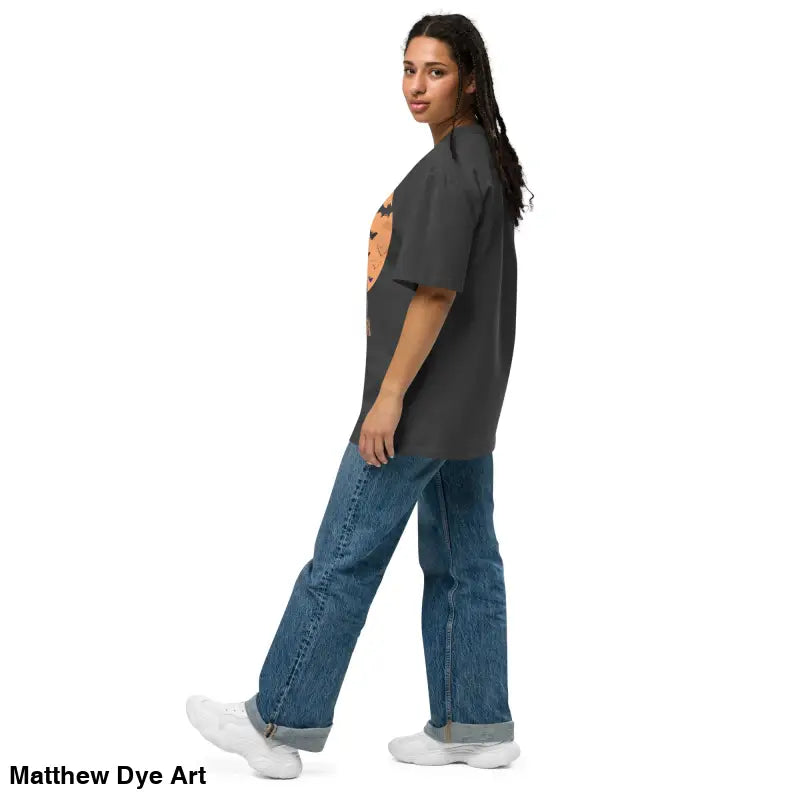 Woman in oversized unisex faded t-shirt and blue jeans for vintage-style Halloween look