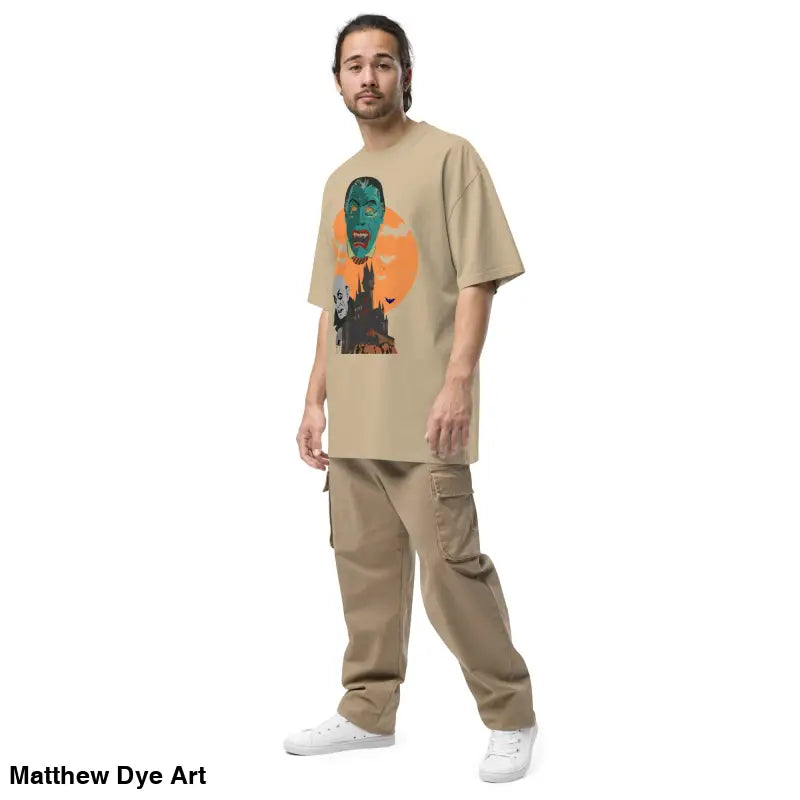 Man in beige oversized unisex faded t-shirt with monster graphic and cargo pants for Halloween