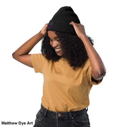Black knit beanie featuring a colorful vintage Halloween cat design for unisex wear