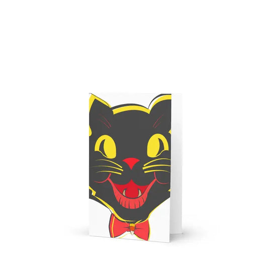 Black cat face with yellow eyes and red bowtie in vintage Halloween greeting card design