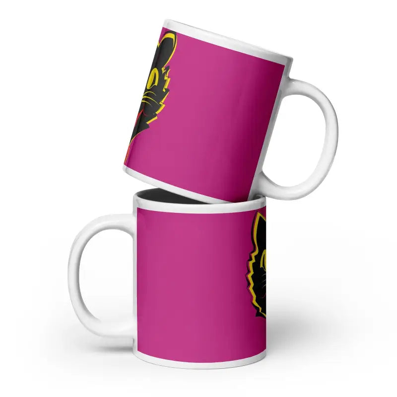 Two stacked pink ceramic mugs featuring a vintage black cat design on the side