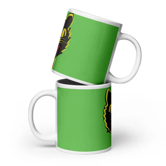 Two stacked green ceramic mugs with black and yellow designs for serene moments