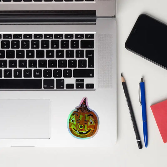 Holographic pumpkin witch sticker from Matthew Dye art, featuring a vintage design
