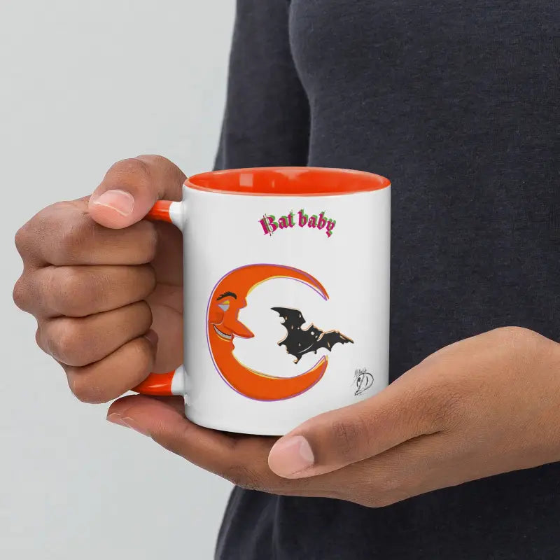 White coffee mug featuring vibrant orange crescent, bat baby design, and black bat silhouette