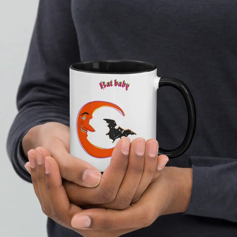 White coffee mug with Halloween design of vibrant orange crescent and black bat silhouette