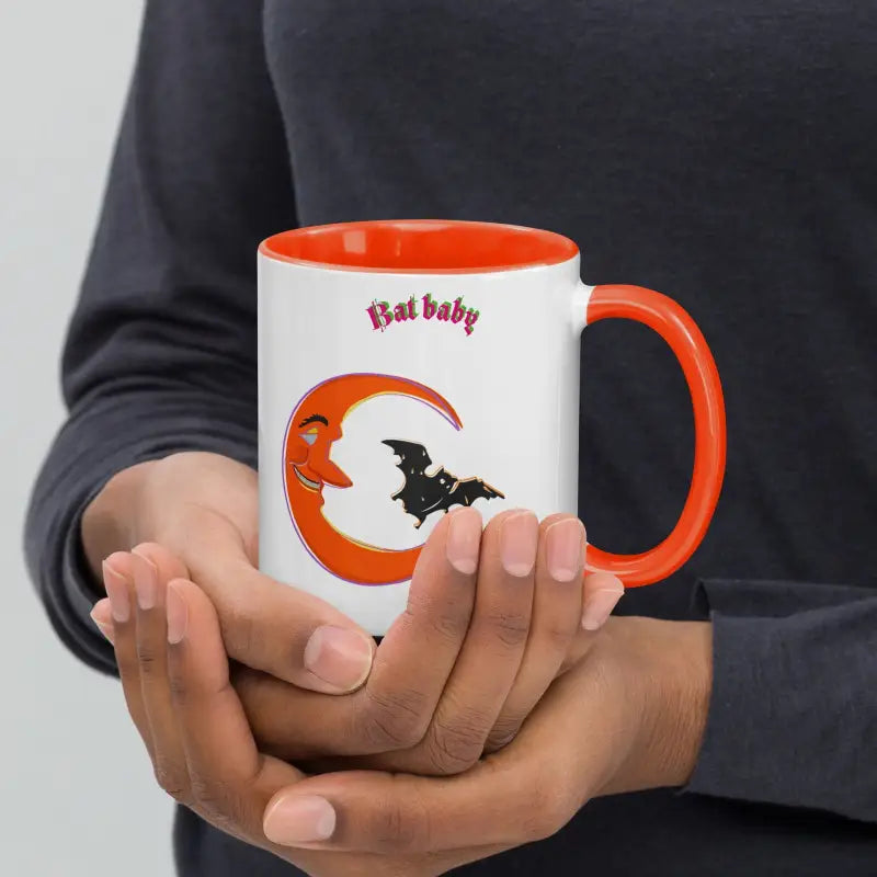 White coffee mug with vibrant orange crescent and black bat silhouette design