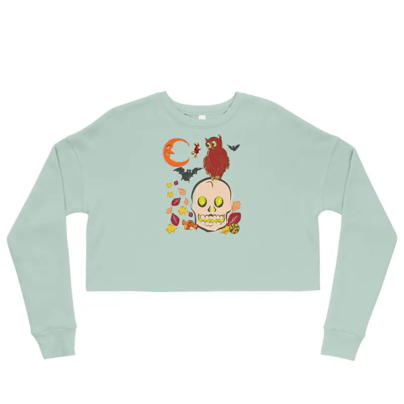 Mint green cropped sweatshirt with Halloween skull, cardinal, and leaves in haunted harvest fleece