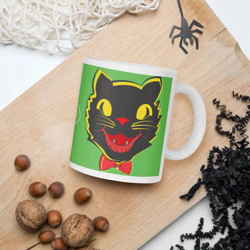 White glossy mug with a retro black cat design featuring yellow eyes and a red bow tie