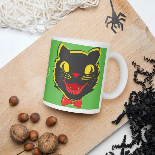 White glossy mug with a retro black cat design featuring yellow eyes and a red bow tie