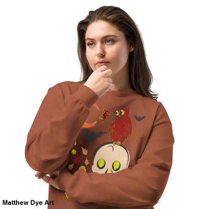 Woman in Halloween sweatshirt featuring vintage owl and skull art design