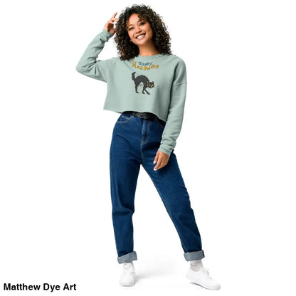 Woman in enchanting mint green cropped sweatshirt featuring a scary cat Halloween design