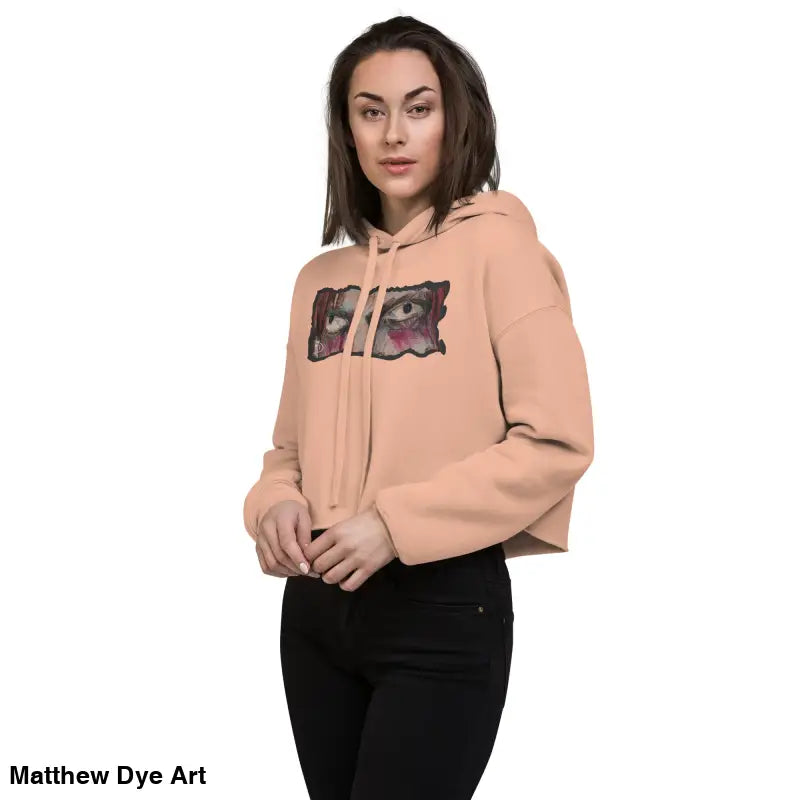 Woman in peach-colored cropped hoodie, a remarkable statement piece for any wardrobe